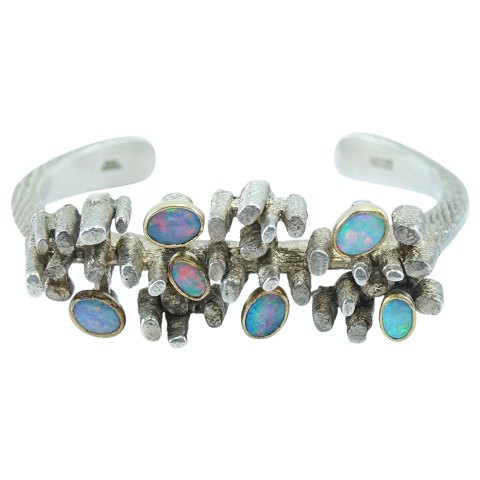 Thor Selzer; A bangle of sterling silver, gilt sterling silver and opals