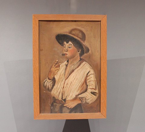 Small painting in brown colors with motif of a boy and simple wooden frame.
5000m2 showroom.
