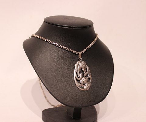 Silver necklace with large pendant with flower motif.
5000m2 showroom.