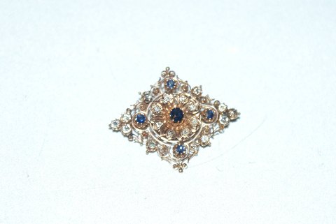 Brooch with sapphire and brilliant-cut diamonds in 14 carat gold