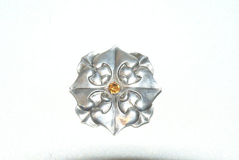 Elegant silver brooch with orange stones
