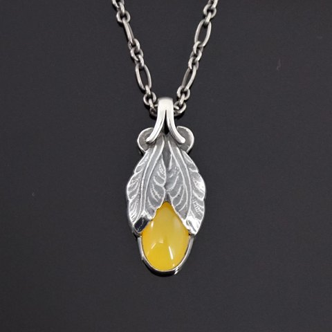 Georg Jensen; Heritage jewellery, 2008, made of sterling silver set with a 
yellow agate