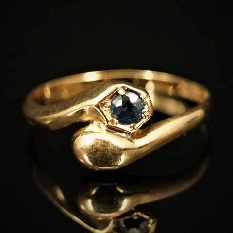 E. L. Weimann; A snake ring of 14k gold set with a sapphire