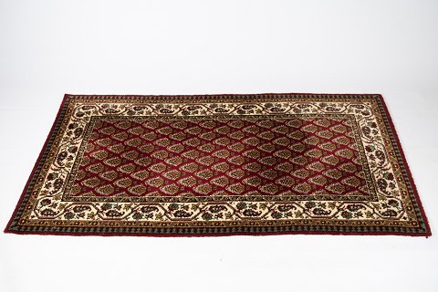 Genuine persian carpet in dark red colors, and in great vintage condition. 
5000m2 showroom.