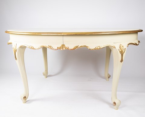 Rococo dining table of white painted wood decorated with leaf gold, and with 
three extension plates, from the 1890s.
5000m2 showroom.
