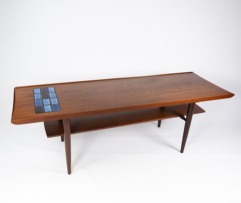Coffee table in teak with blue tiles of danish design from the 1960s.
5000m2 showroom.
