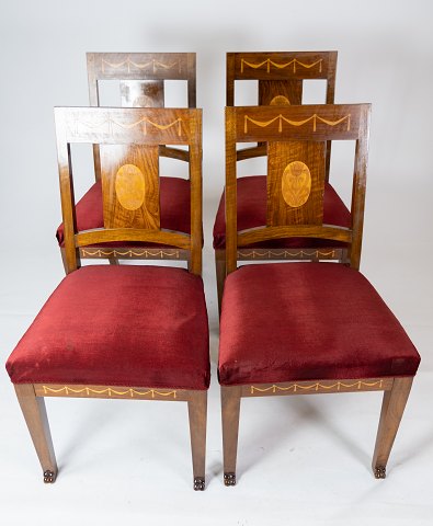 Set of four dining room chairs of walnut with inlaid wood and upholstered with 
red velvet from around 1910.
5000m2 showroom.