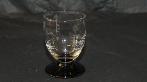 Shot glass with black base and grape vine