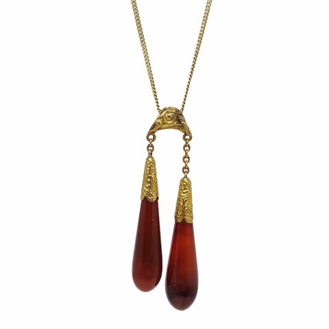 A long necklace in 14k gold set with carnelians
