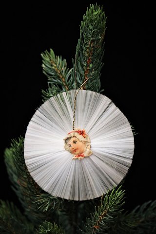 Old Christmas ornament of angel hair and small glossy images from around 1920...