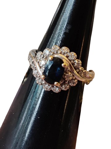 14 carat white gold ring with sapphire surrounded by 18 diamonds