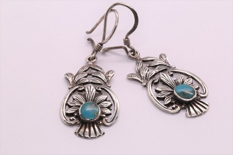 Beautiful and rustic earrings with inlaid turquoise.