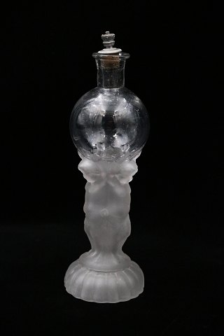 Decorative, old mouth-blown glass decanter with a motif of a child carrying a 
glass ball...