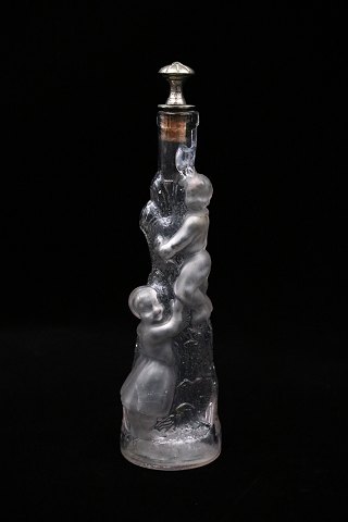 Decorative, old mouth-blown glass carafe with a motif of children climbing up a 
tree trunk...