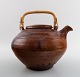 Gutte Eriksen own workshop, tea pot in ceramics. Handle in wicker.
Stamped: Gutte.