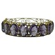 A bangle of gilted silver set with amethysts