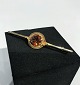 Brooch in 14 ct. gold with amber colored stone.
5000m2 showroom.