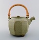 Danish ceramist. Tea pot in ceramics. Handle in wicker.