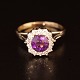 An amethyst ring with 14 diamonds mounted in 14k white gold
