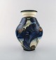 Danico, Denmark. Large glazed stoneware vase in modern design. Blue flowers on 
light background. 1920