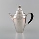 L'Art presents: 
Rare Georg 
Jensen coffee 
pot in sterling 
silver with 
ebony handle. 
Dated 1915-30.

