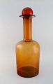 Otto Brauer for Holmegaard. Kolossal vase/flaske i brunt kunstglas med rød 
kugle. 1960