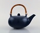 Eva Stæhr-Nielsen for Saxbo. Teapot in glazed ceramics with handle in wicker. 
Beautiful glaze in shades of blue. 1940 / 50