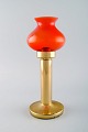 HANS-AGNE JAKOBSSON for A / B MARKARYD. Oil lamps in brass and red art glass. 
1960 / 70