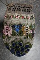 Antik Perletaske
Taske lavet som perlebroderi med smukt mønster 
bl.a. blomst/rose
Posefacon med snøre i toppen for kombineret 
lukning og "hank"
Tasken har mange perler og er derfor af en 
væsentlig vægt
L: 17cm
