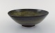 Gunnar Hartman (b. 1949), Sweden. Bowl on foot in glazed ceramics. Beautiful 
black glaze with yellow touches. Late 20th century.
