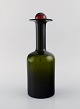 Otto Brauer for Holmegaard. Large vase / bottle in green art glass with red 
ball. 1960