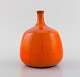 Georges Jouve School. Vase in glazed ceramics. Beautiful orange running glaze. 
France, mid-20th century.
