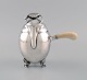 Georg Jensen Blossom chocolate pot in hammered sterling silver with handle of 
ivory. Model 2A. Dated 1915-1930.
