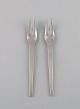 Two Georg Jensen Caravel cold meat forks in sterling silver.
