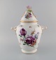 Large antique Dresden ornamental vase in hand-painted porcelain. Flowers and 
gold decoration. Rose in relief on the lid. Ca. 1900.
