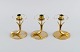 Gunnar Ander for Ystad Metall. Three candlesticks in brass and clear art glass 
shaped like flowers. 1950s.
