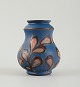 Kähler, Denmark, glazed stoneware vase in modern design. 1930/40s. Cow horn 
technique. Brown leaves on blue background.