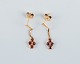 Unknown goldsmith, a pair of earrings adorned with semi-precious stones.