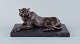 Large and heavy sculpture of a cheetah in patinated bronze on a marble base.
