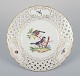 Meissen, Germany. Open lace porcelain plate. Hand-painted with a bird motif and 
insects, gold trim.