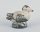 Royal Copenhagen figurine in stoneware of an eider duck. Knud Kyhn.
Glaze in shades of blue-green and sand.