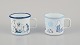 Muurla, Finland. Two enamel mugs with handles. Featuring illustrations of 
Moomins.