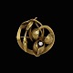 Broche i 14k 
guld med 
brillant 
0.10ct.