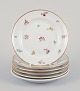 Six small porcelain plates. Hand-painted with polychrome floral motifs and gold 
rims.