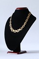 Block gold necklace in 14 carat gold with 3 rows in sequence, and box lock. 
Stamped GIFA 585.
SOLD