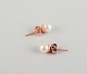 Swedish goldsmith. A pair of classic ear studs in 18 karat gold adorned with cultured pearls.