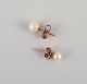 Swedish goldsmith. A pair of classic ear studs in 18 karat gold adorned with 
cultured pearls.