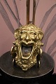 Decorative, funny old ashtray in brass in the shape of the face of a mythical 
creature, a sphinx...