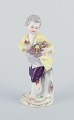 Meissen. Porcelain figurine of boy with basket of flowers.