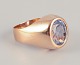 18 karat gold ring adorned with light blue semi-precious stones.